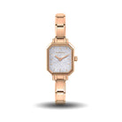 Rose gold watch with a glittery face on a white background