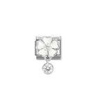 Silver charm with a white flower and clear gemstone on a white background
